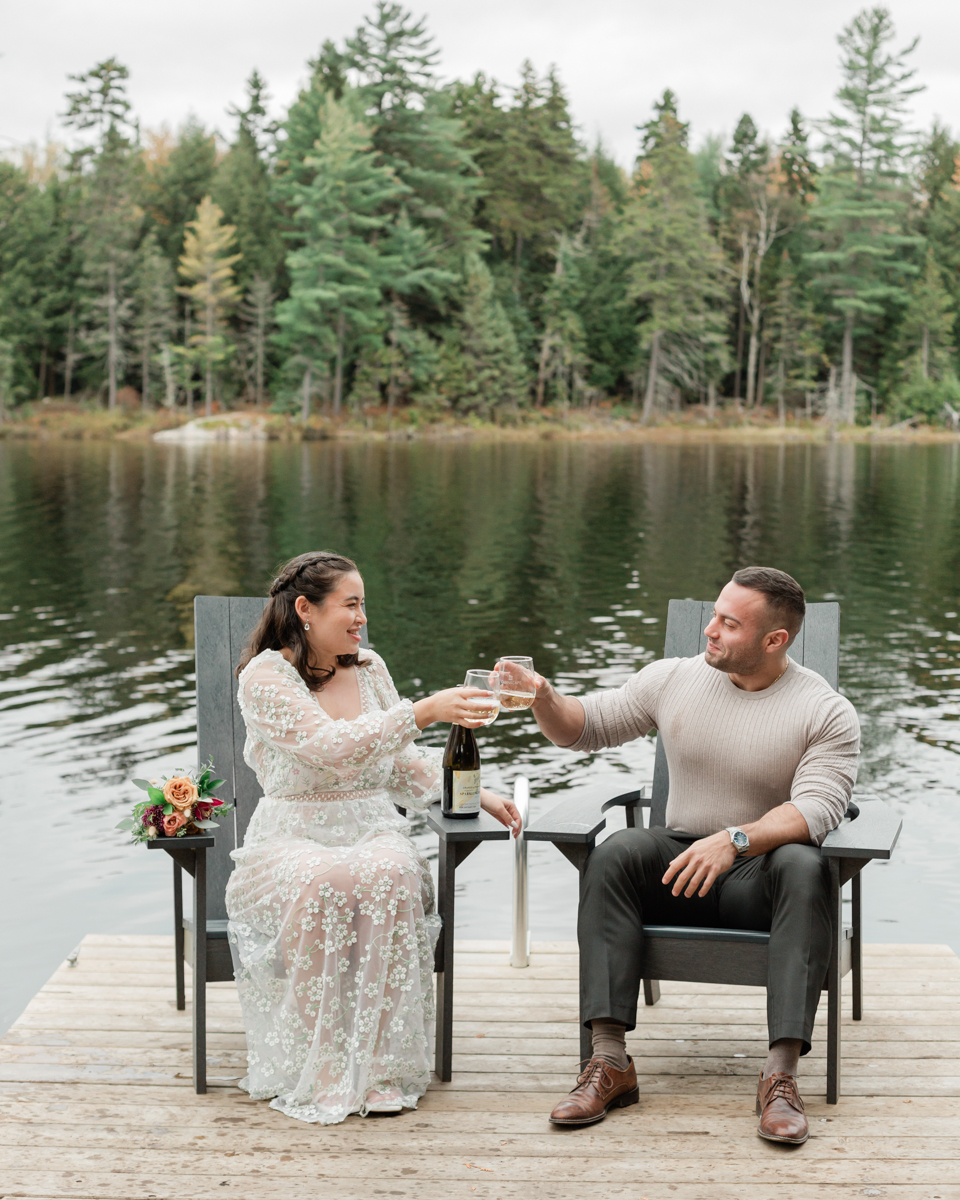 A couple that just got married in Haliburton Forest and are celebrating with a champagne pop