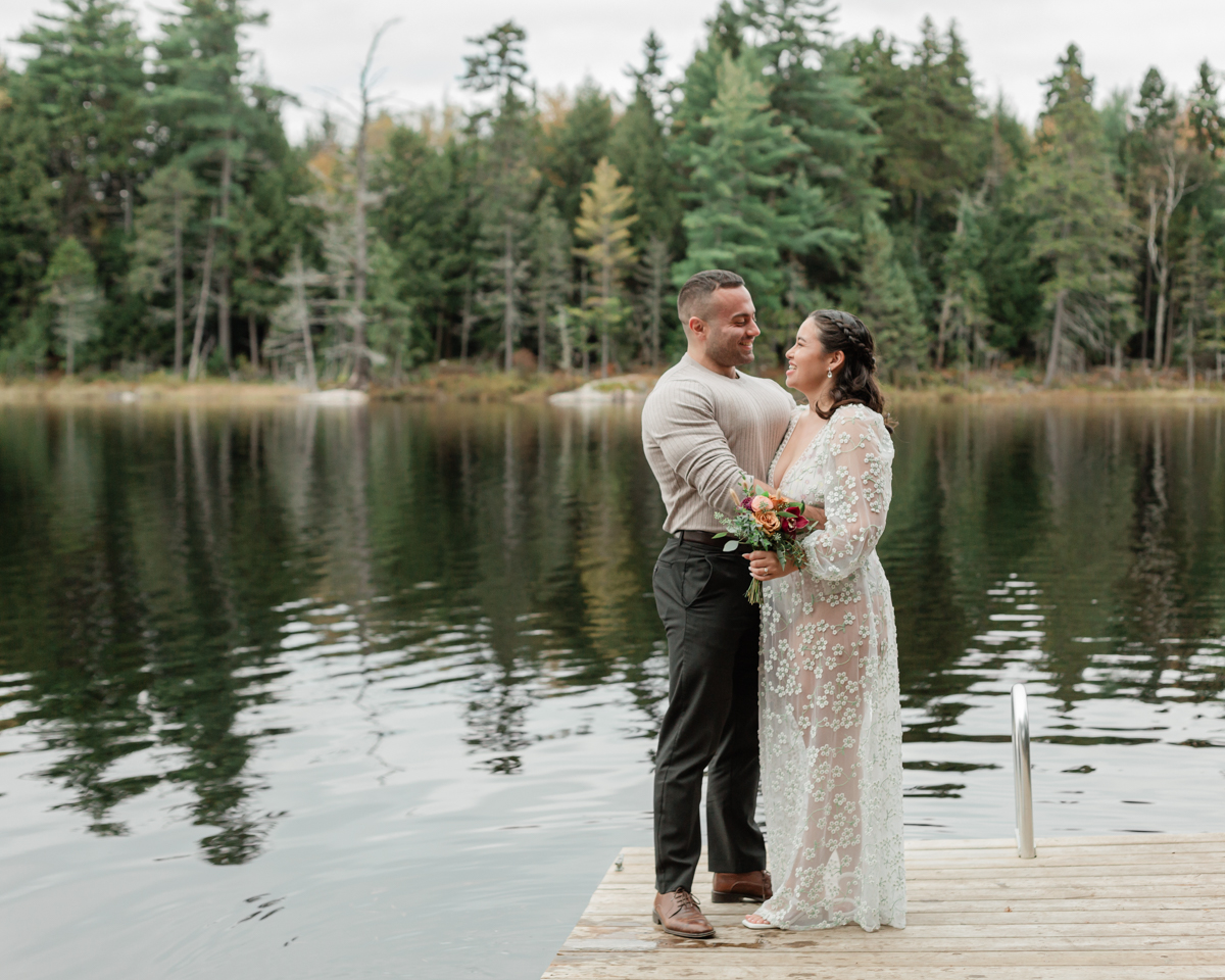 A couple laughing and embracing on a Muskoka doc post elopement 