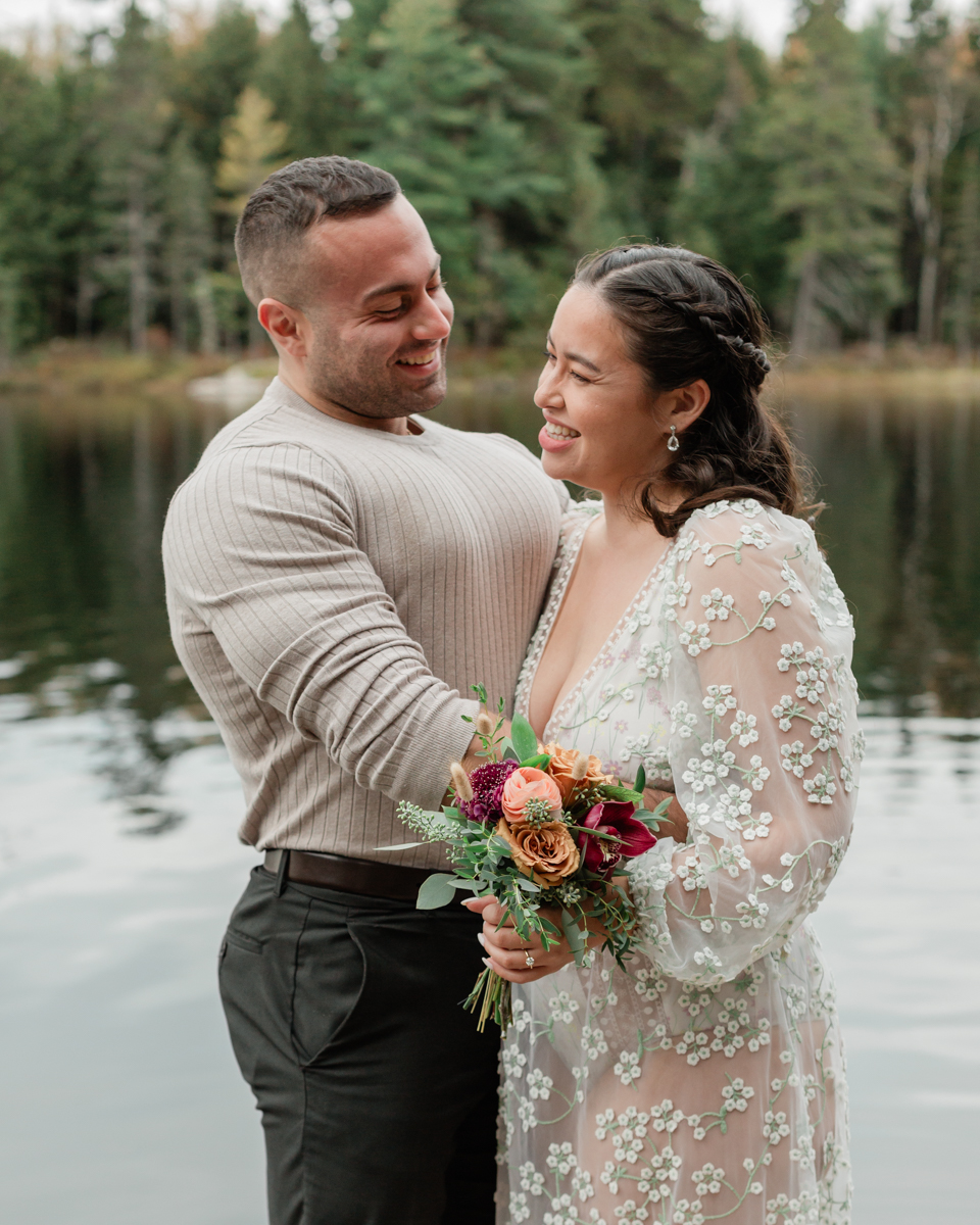 A couple laughing and embracing on a Muskoka doc post elopement 