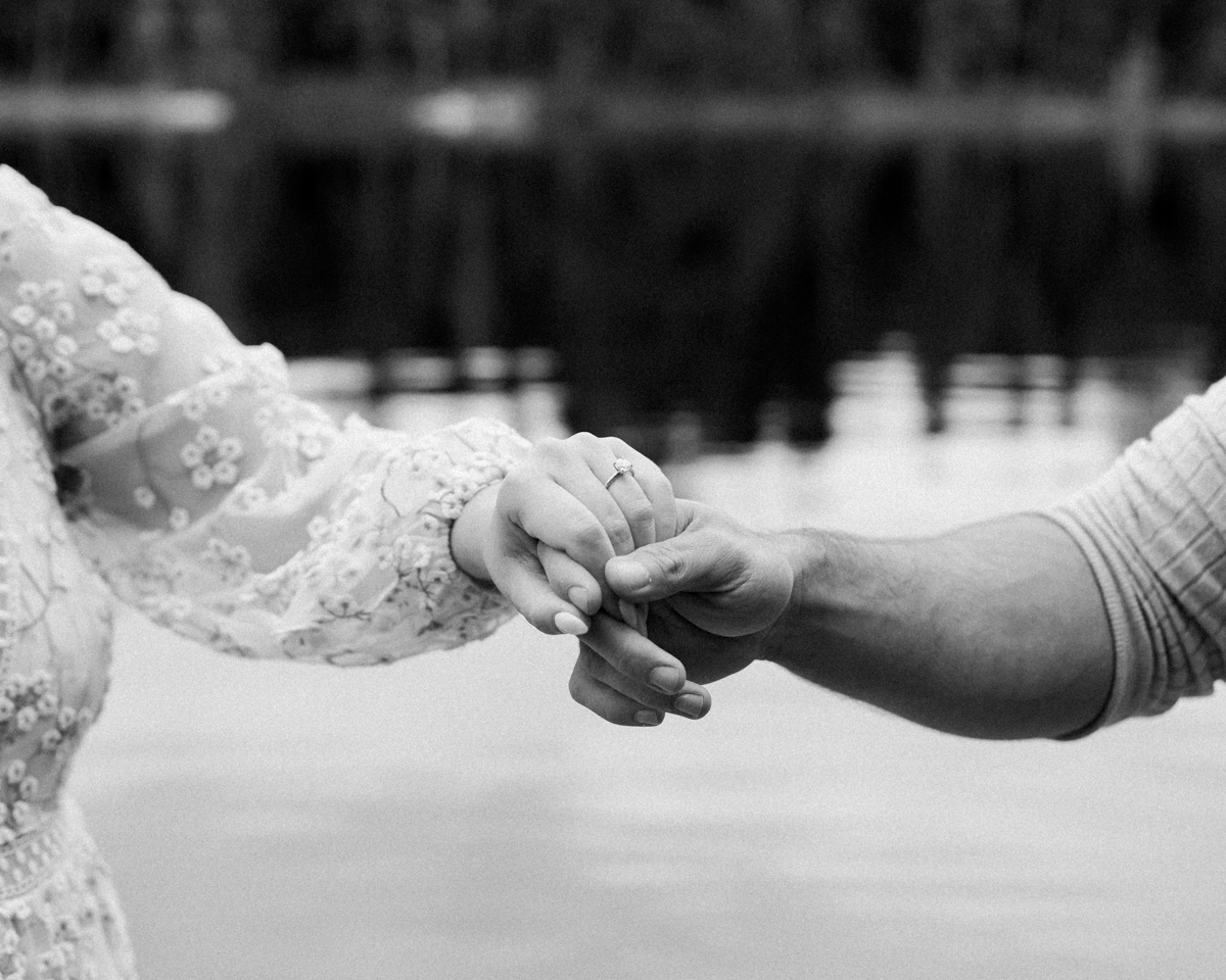 A couple kissing on a Muskoka lakefront after their wedding 