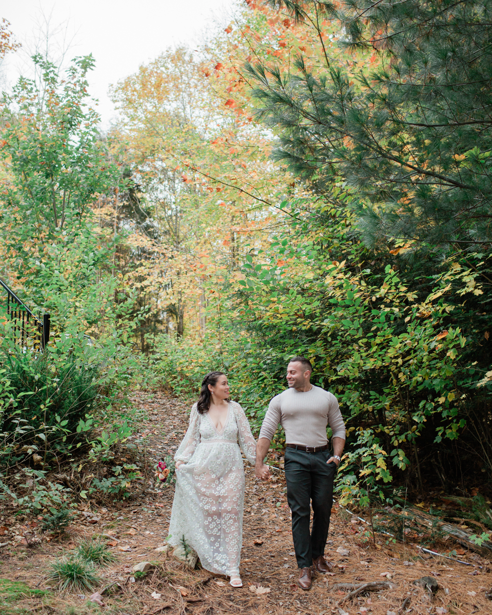 A couple kissing in front of their Muskoka off grid cabin after their wedding 