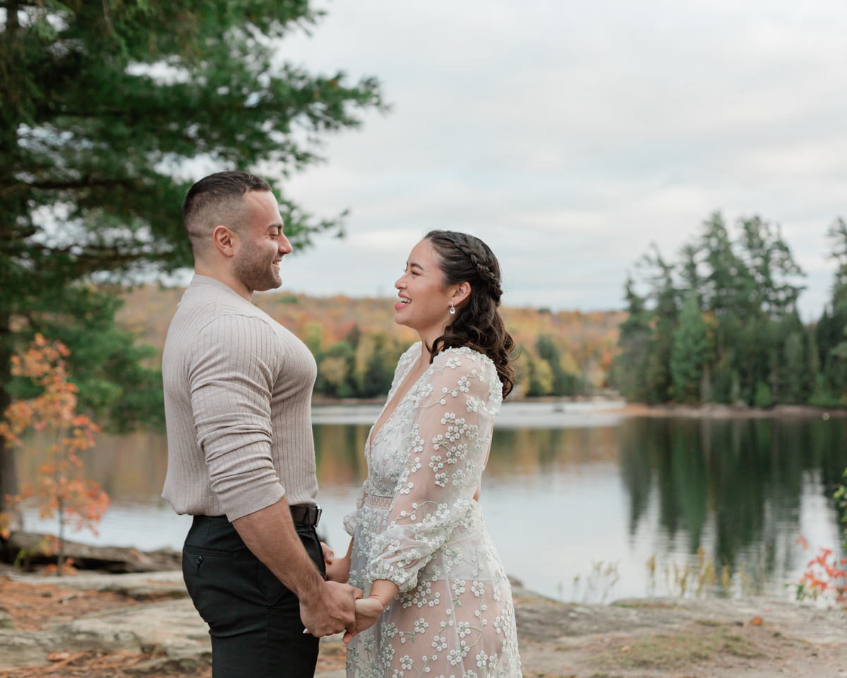 A couple kissing on a Muskoka lakefront after their wedding 