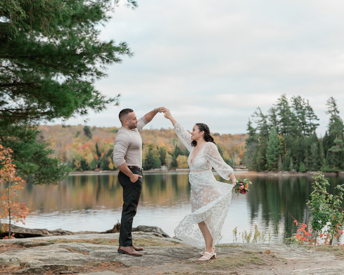 A couple kissing on a Muskoka lakefront after their wedding 