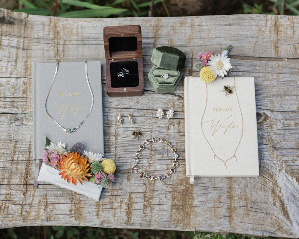 Vow books and rings from Amber and Laurens LGBTQ+ elopement at Moraine Lake Lodge in Banff National Park