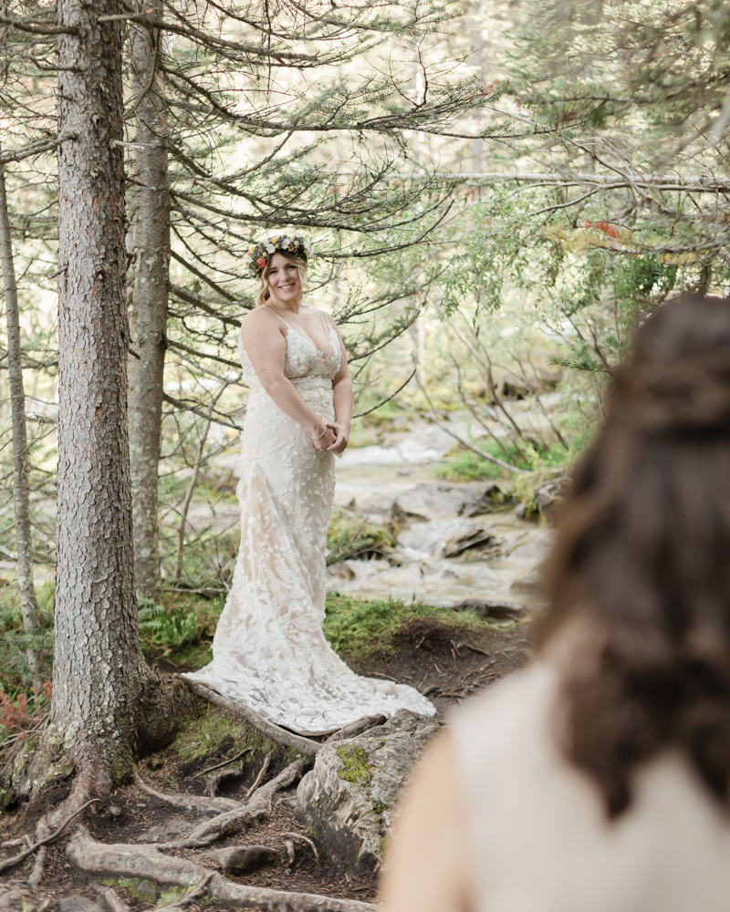 A couple exchanging vows and rings for their LGBTQ+ waterfall Banff elopement