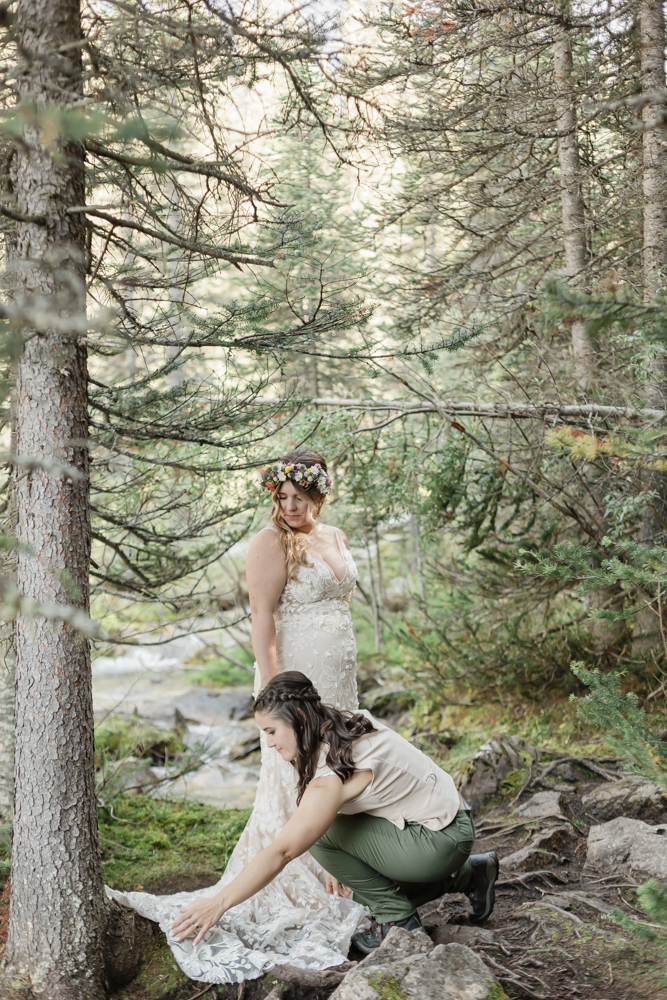 A couple exchanging vows and rings for their LGBTQ+ waterfall Banff elopement