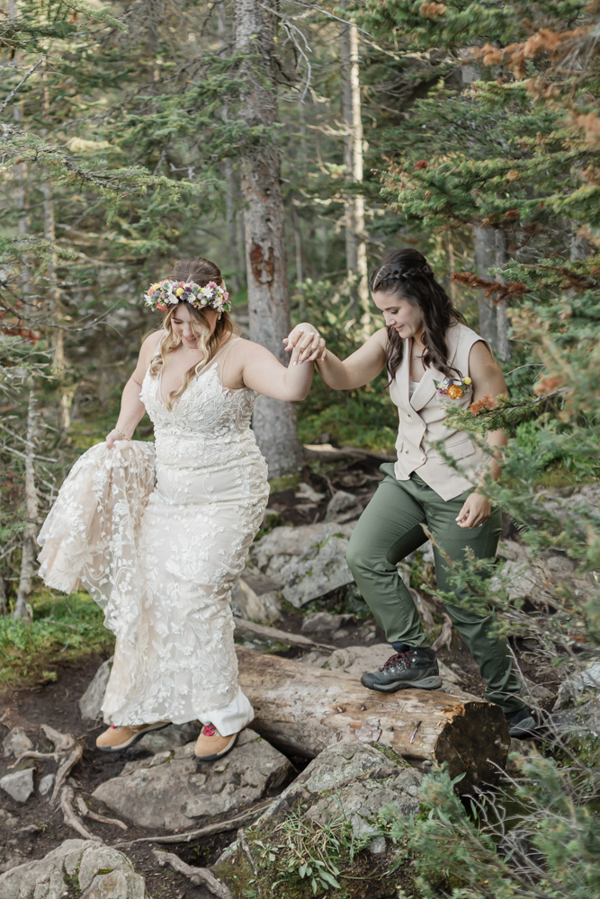 A couple laughing and embracing at Moraine Lake for their LGBTQ+ Banff elopement