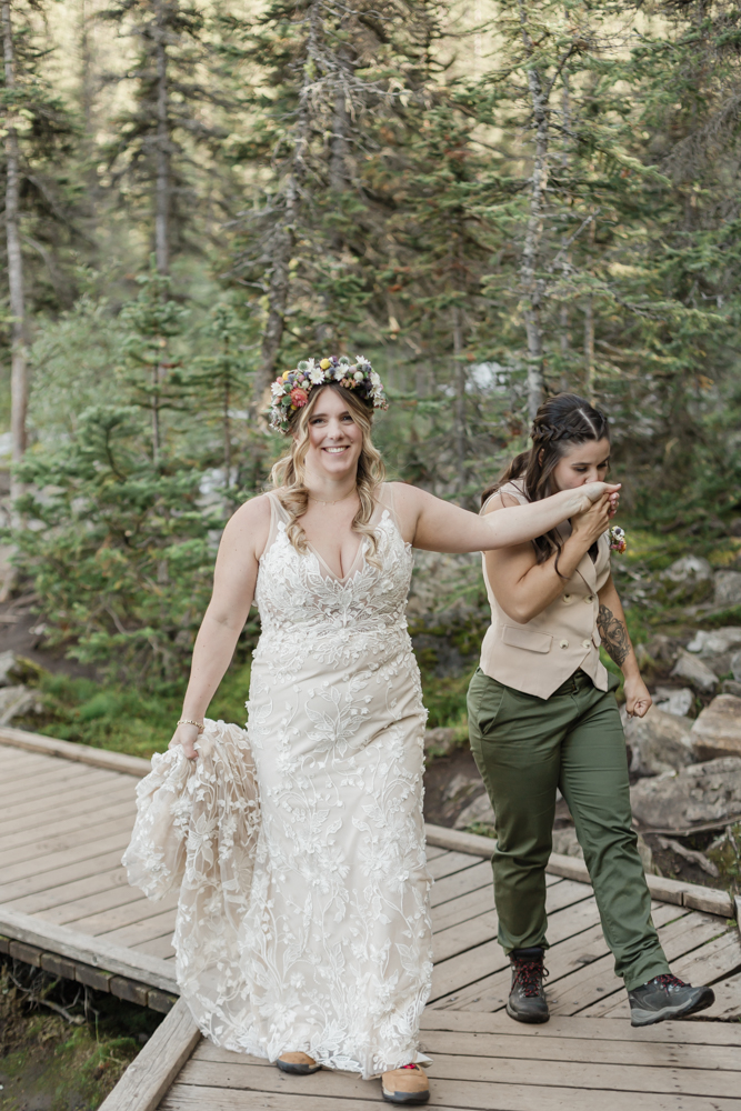 A couple laughing and embracing at Moraine Lake for their LGBTQ+ Banff elopement