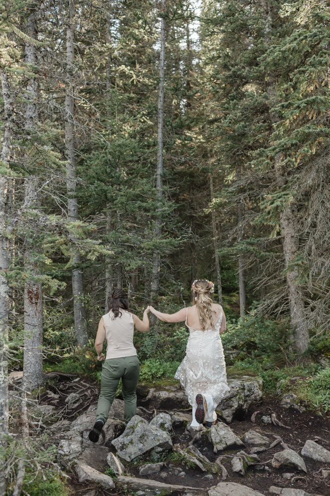 A couple laughing and embracing at Moraine Lake for their LGBTQ+ Banff elopement