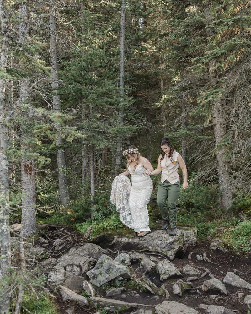 A couple laughing and embracing at Moraine Lake for their LGBTQ+ Banff elopement