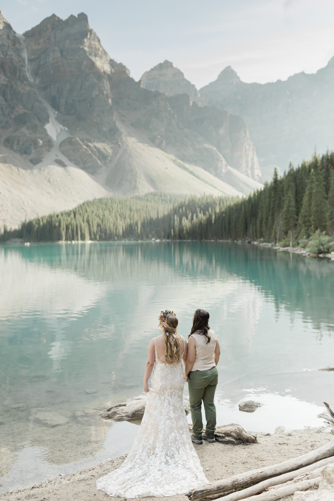 A couple holding hands at Moraine Lake for their LGBTQ+ Banff elopement