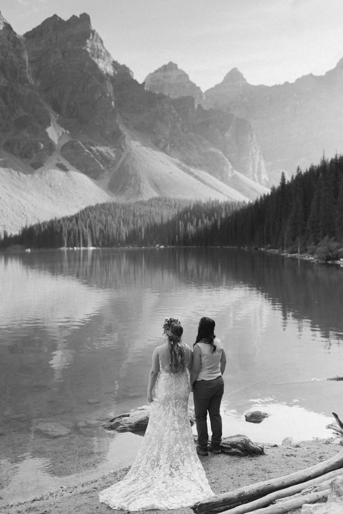 A couple laughing and embracing at Moraine Lake for their LGBTQ+ Banff elopement