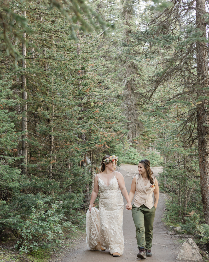 A couple laughing and embracing at Moraine Lake for their LGBTQ+ Banff elopement