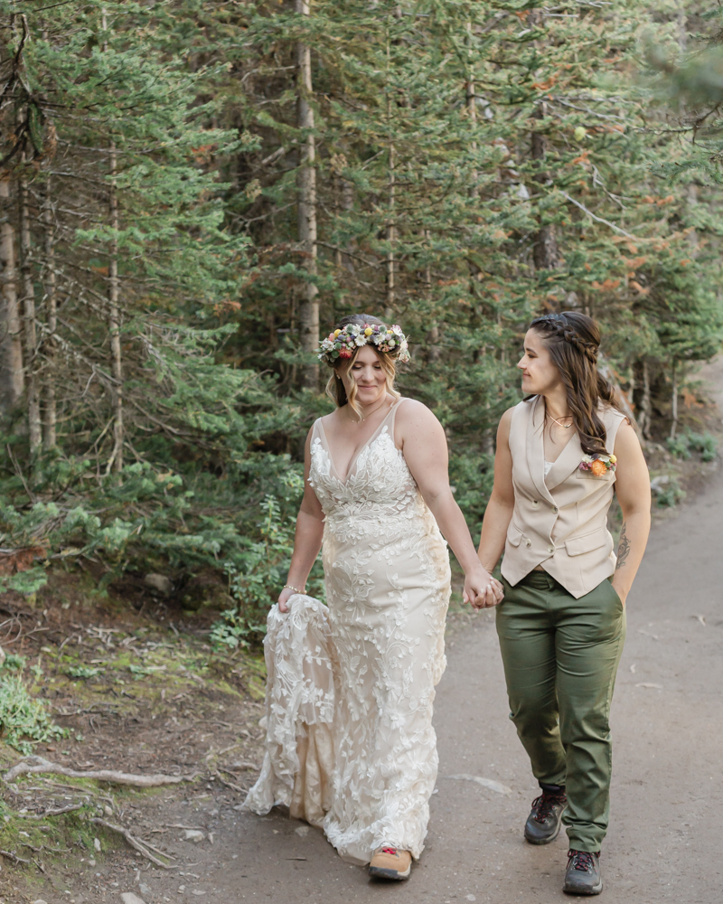 A couple laughing and embracing at Moraine Lake for their LGBTQ+ Banff elopement