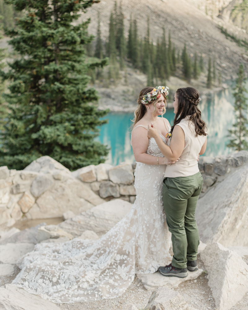 A couple kissing in front of Moraine Lake for their LGBTQ+ Banff elopement