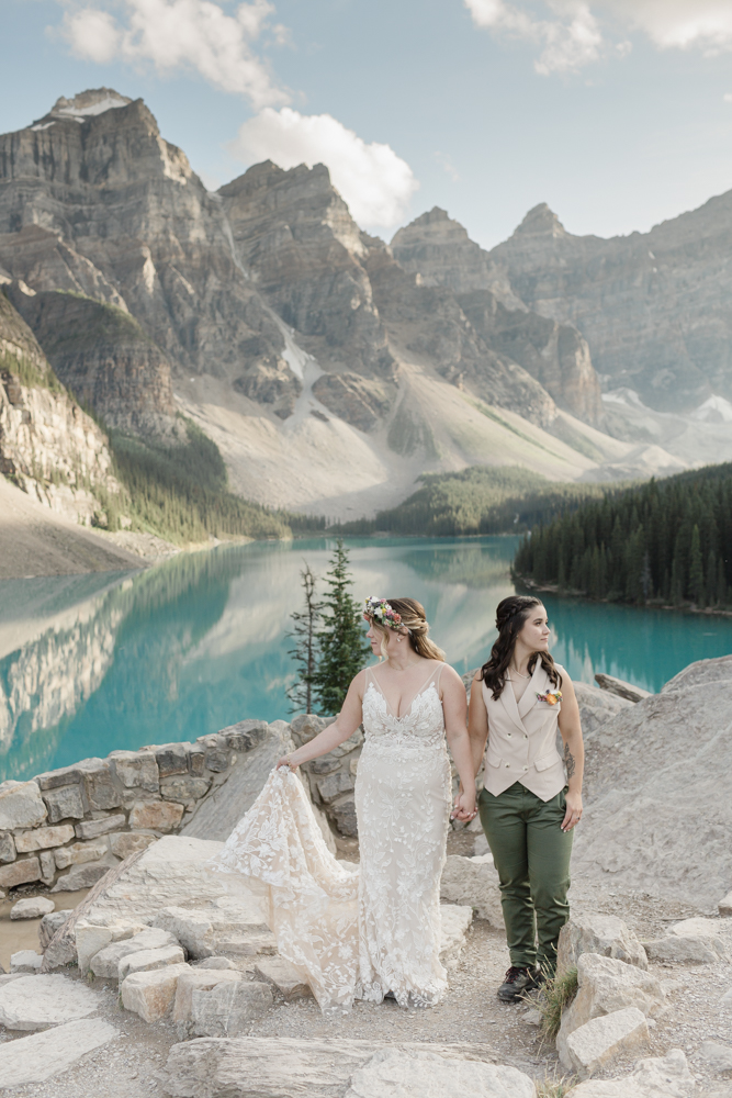 A couple kissing in front of Moraine Lake for their LGBTQ+ Banff elopement