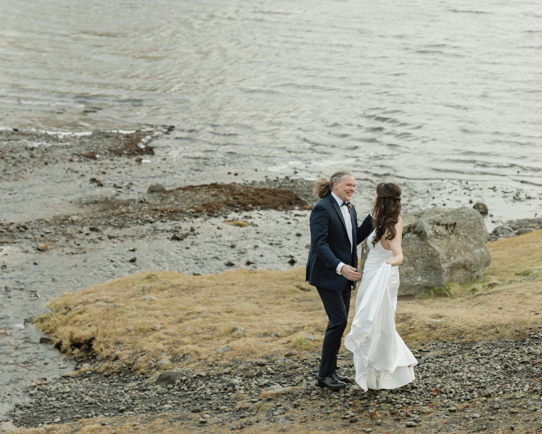 Kristen and Adam having their first look while facing Kirkjufell mountain in Iceland