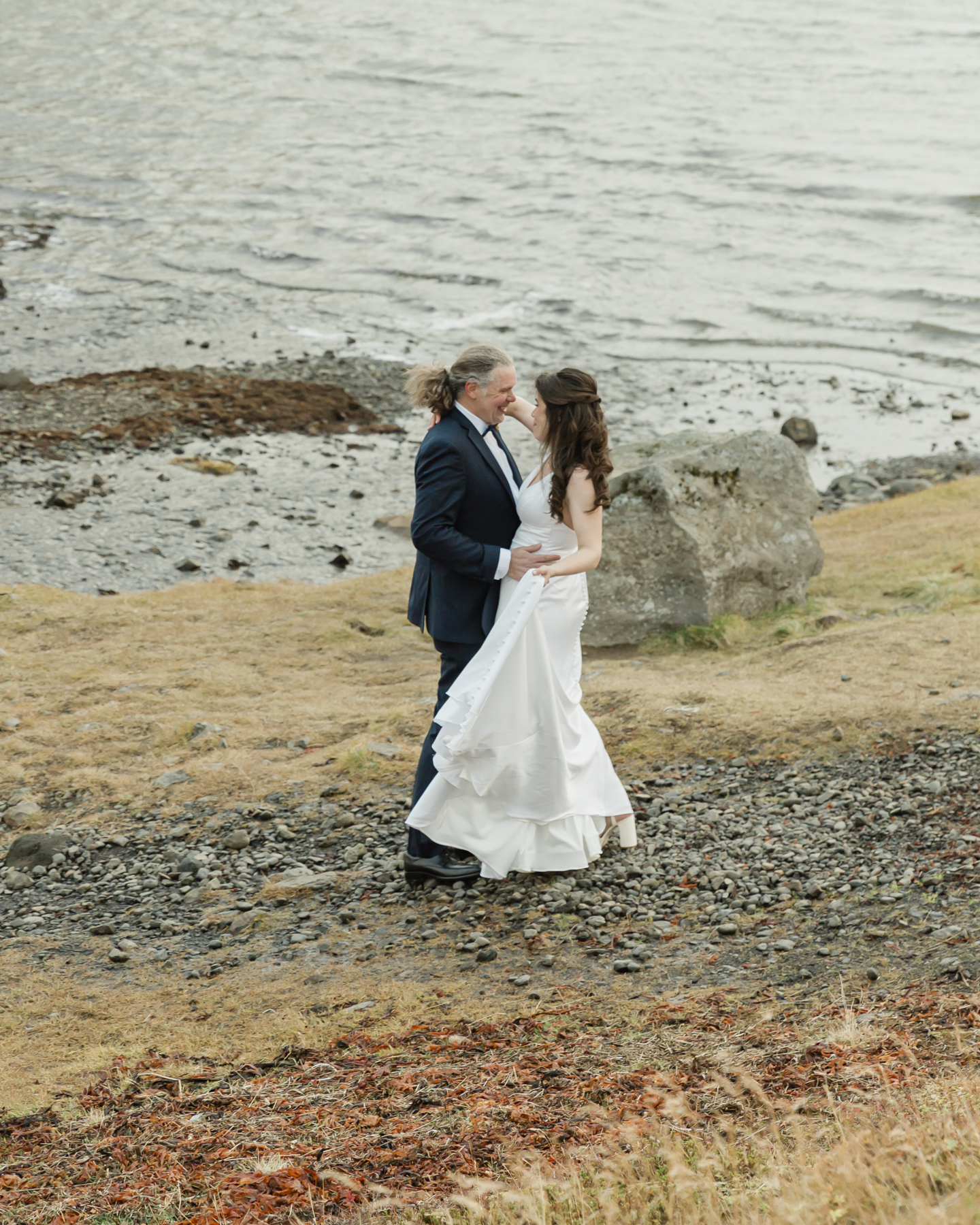 Kristen and Adam having their first look while facing Kirkjufell mountain in Iceland