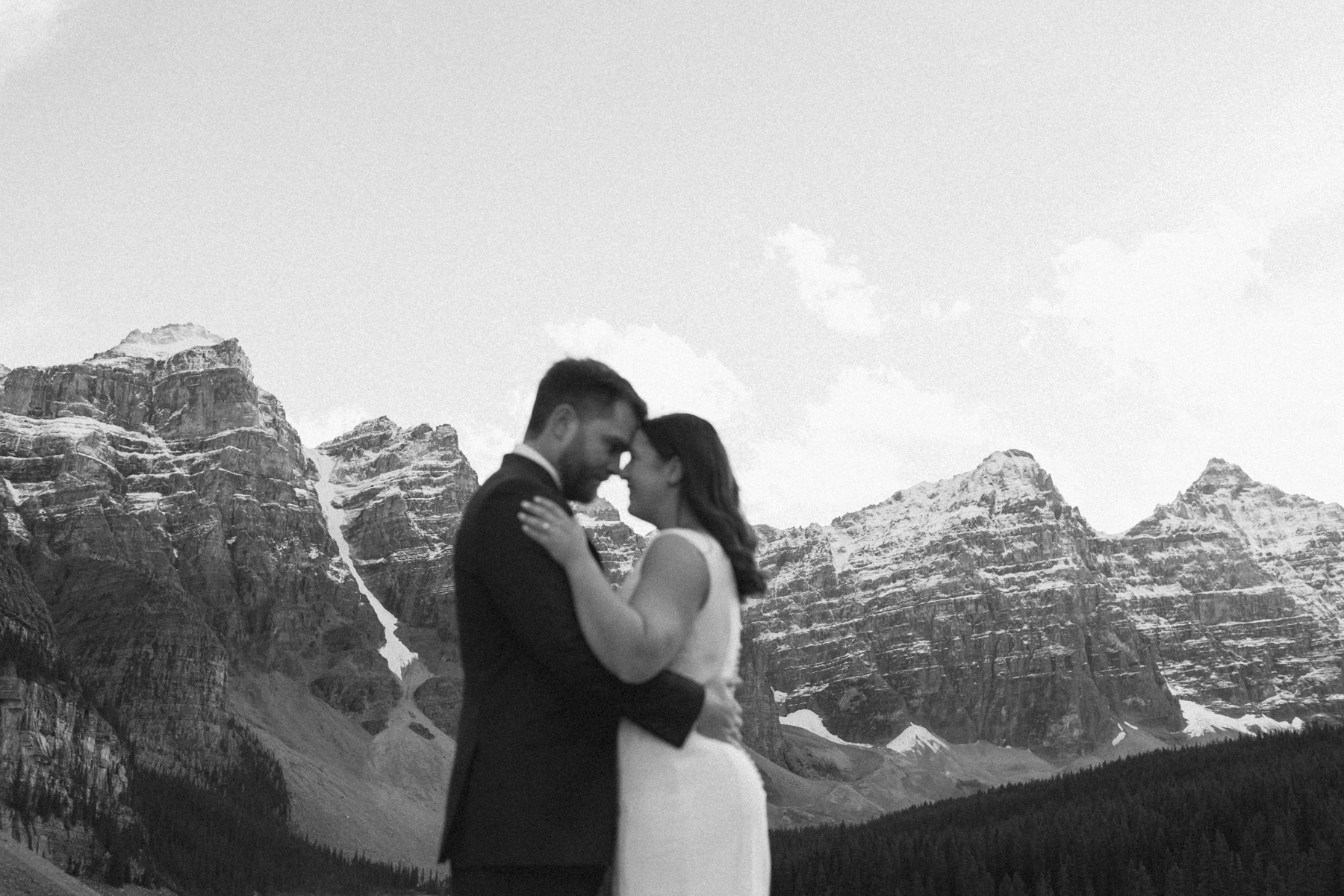 A looking at the mountains at Moraine Lake during their elopement 