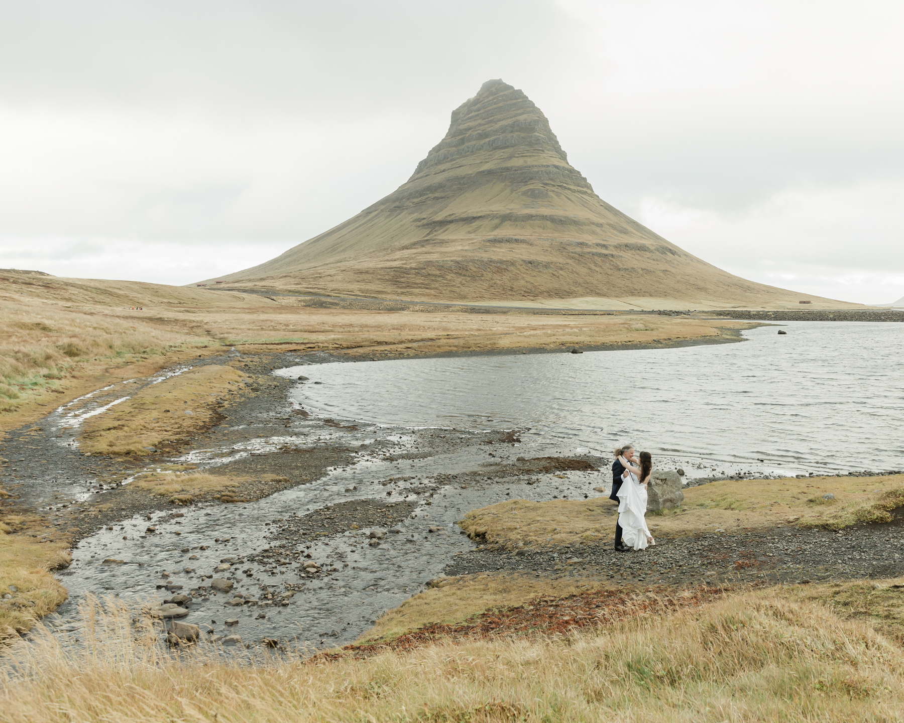 Kristen and Adam having their first look while facing Kirkjufell mountain in Iceland