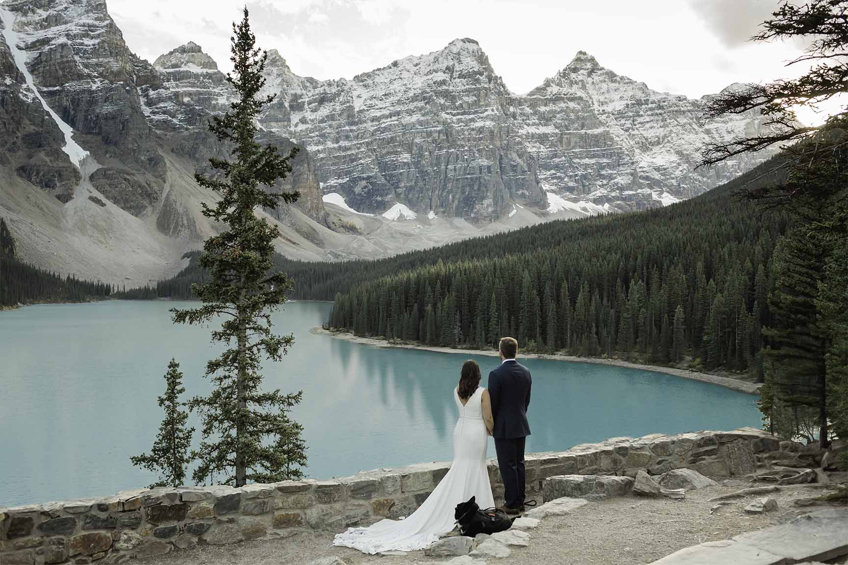 A looking at the mountains at Moraine Lake during their elopement 