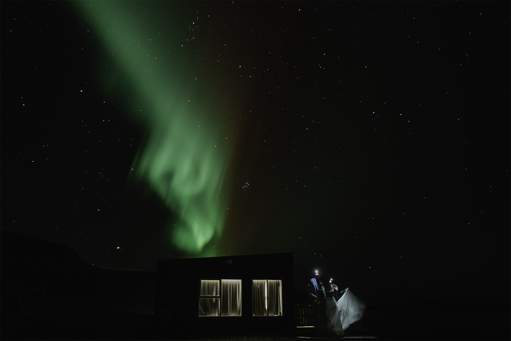 Kristen and Adam enjoying the Northern Lights during their Snæfellsnes Peninsula elopement in Iceland 