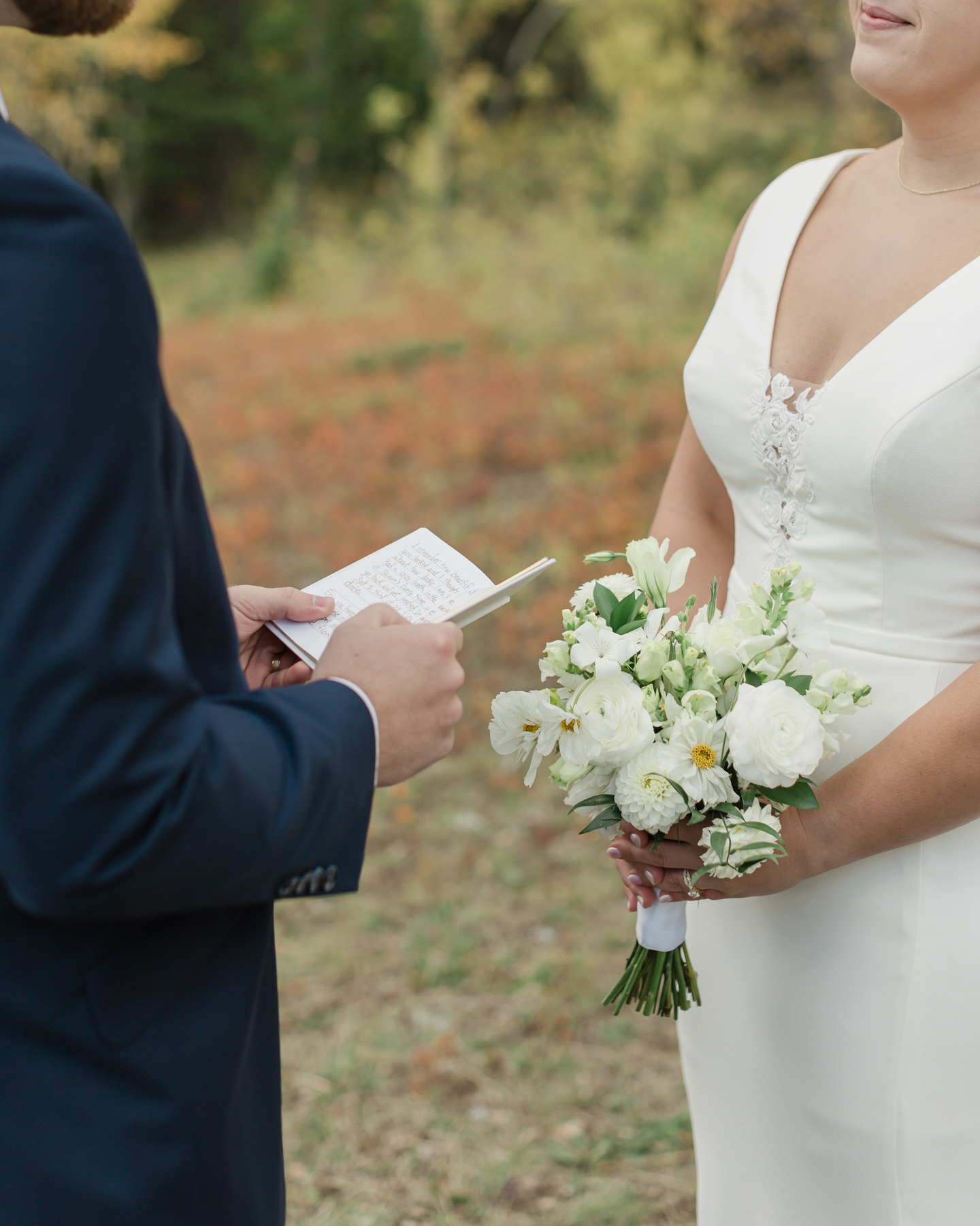 A couple exchanging vows and rings during their Kananaskis Country ceremony