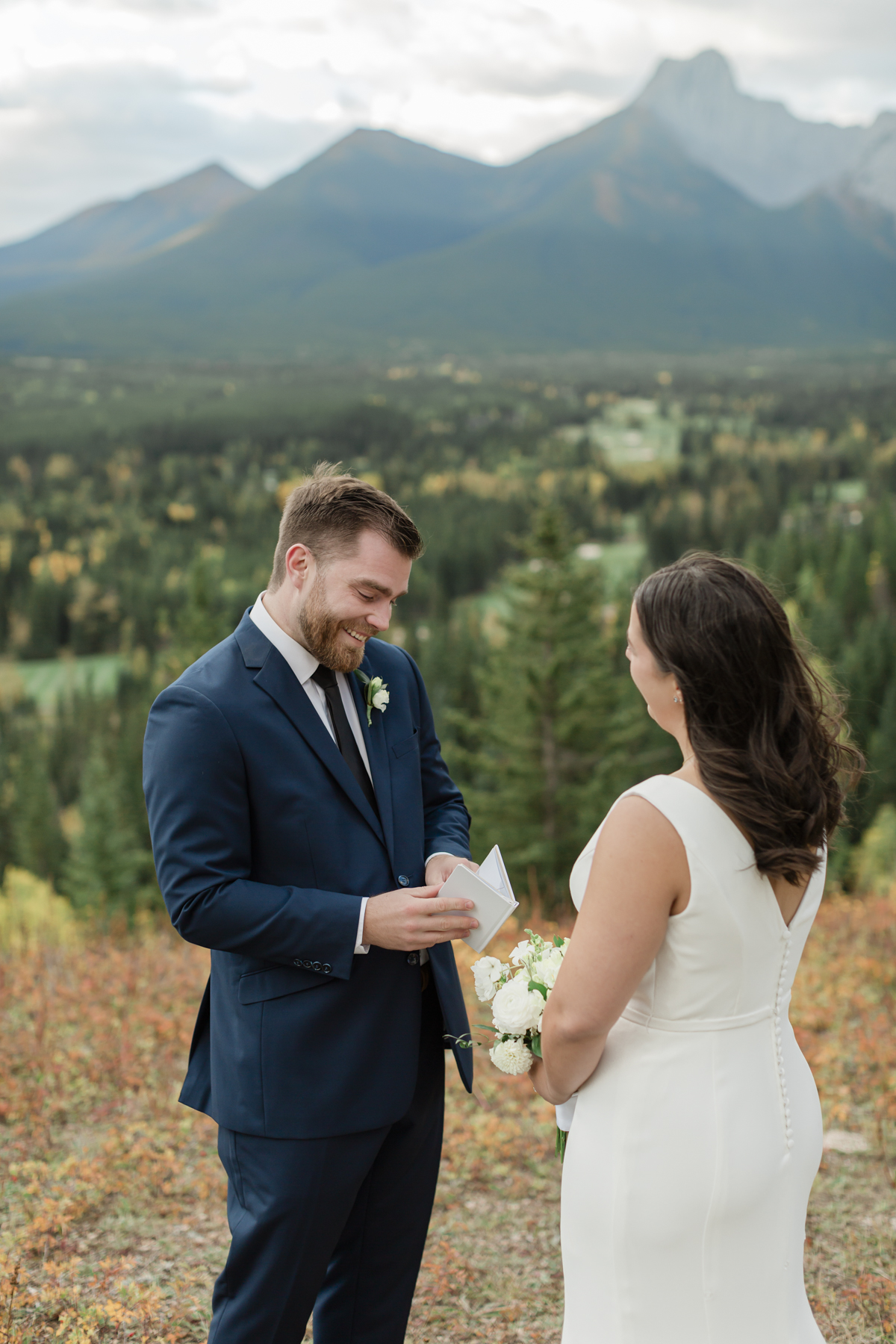 A couple exchanging vows and rings during their Kananaskis Country ceremony