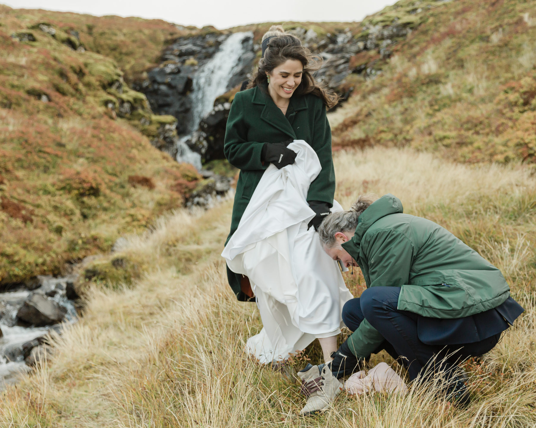 Adam helping Kristen put on her shoes at Kirkjufell mountain