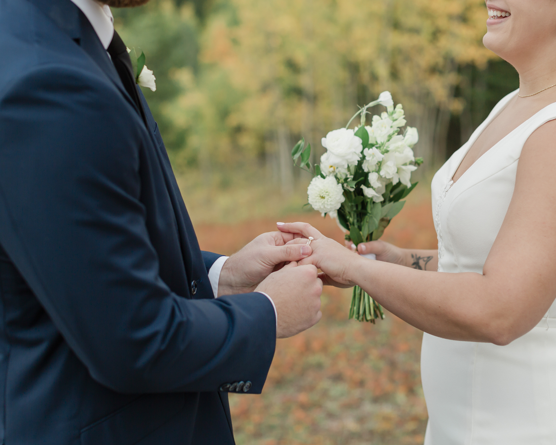 A couple exchanging vows and rings during their Kananaskis Country ceremony