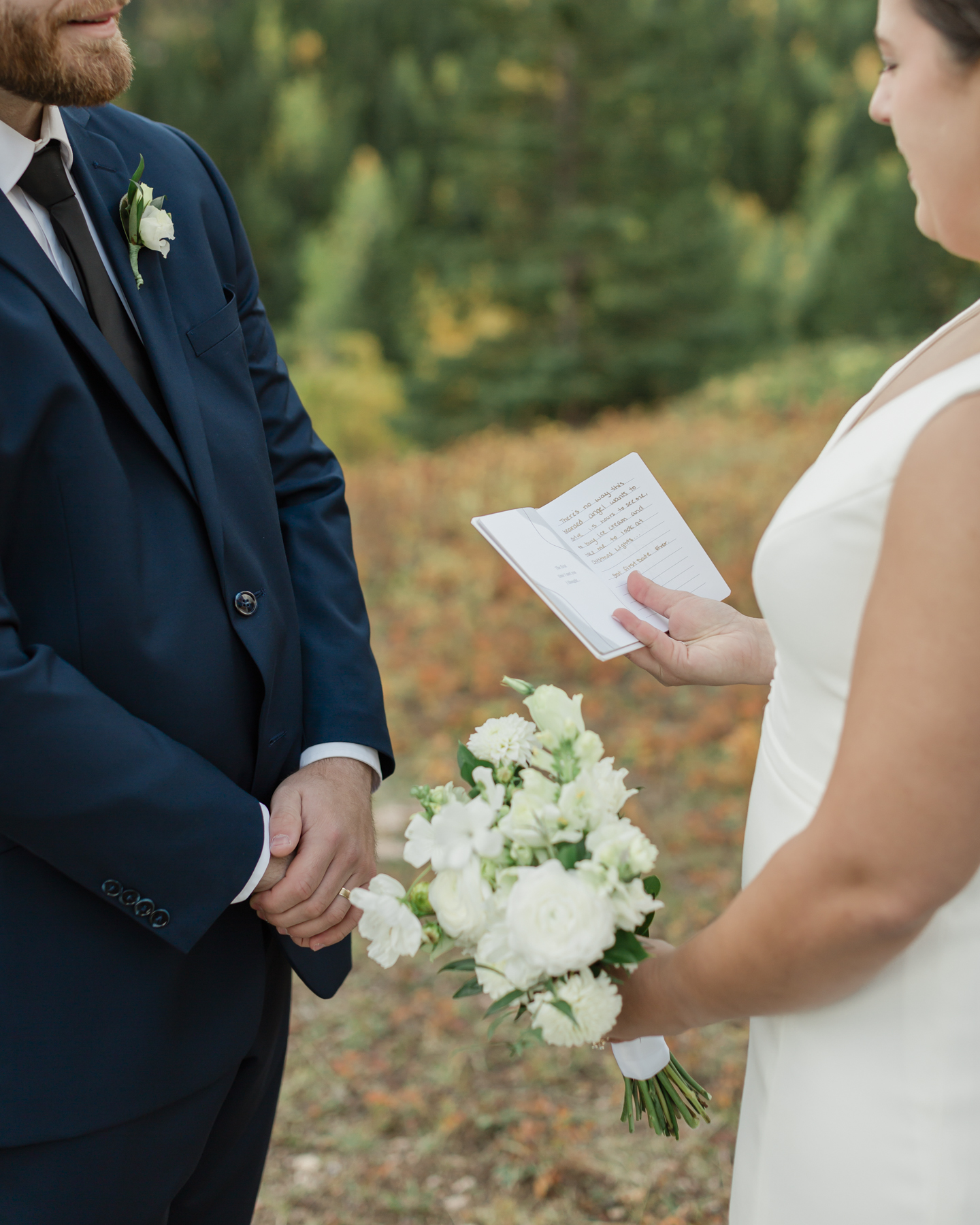 A couple exchanging vows and rings during their Kananaskis Country ceremony