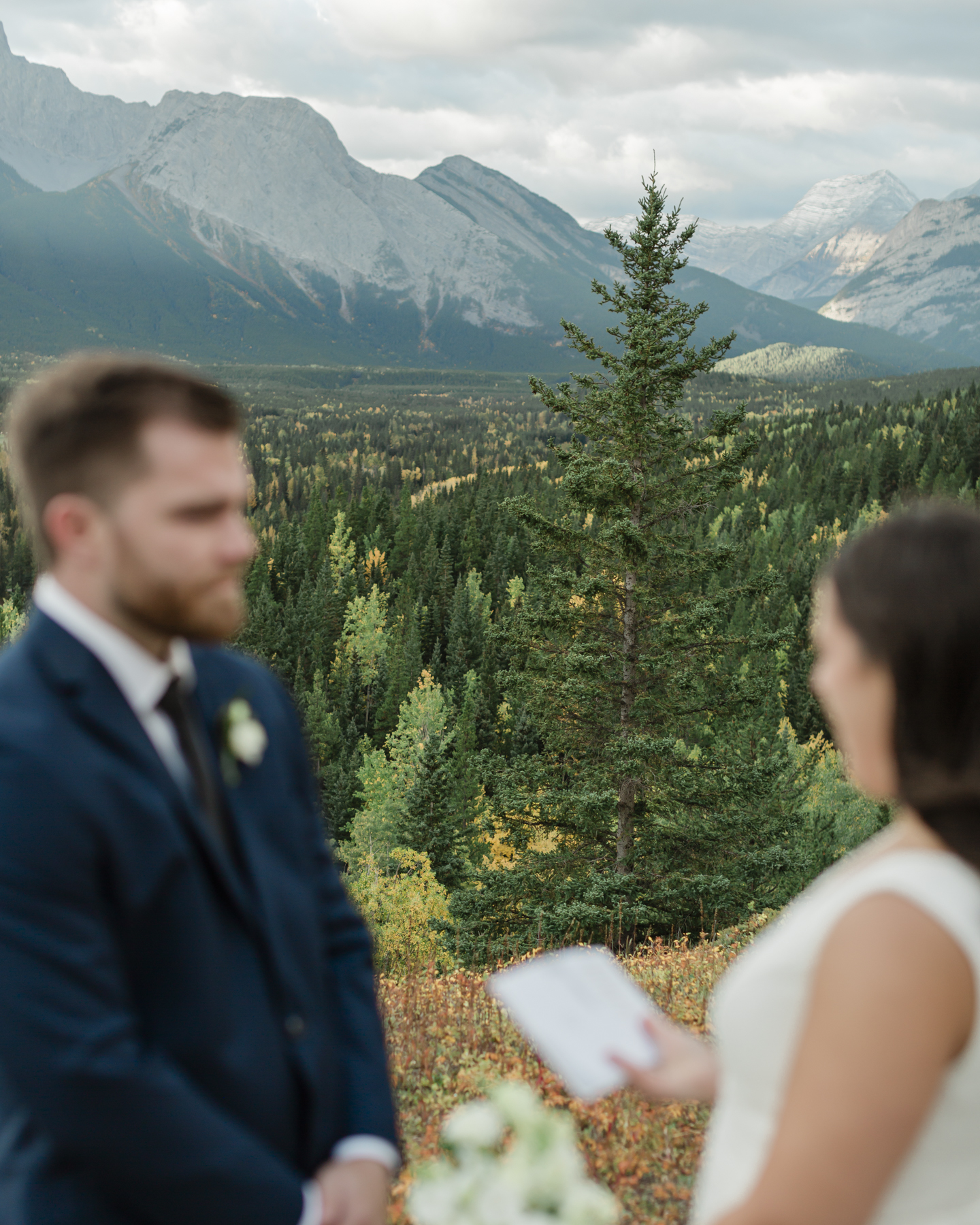 A couple exchanging vows and rings during their Kananaskis Country ceremony