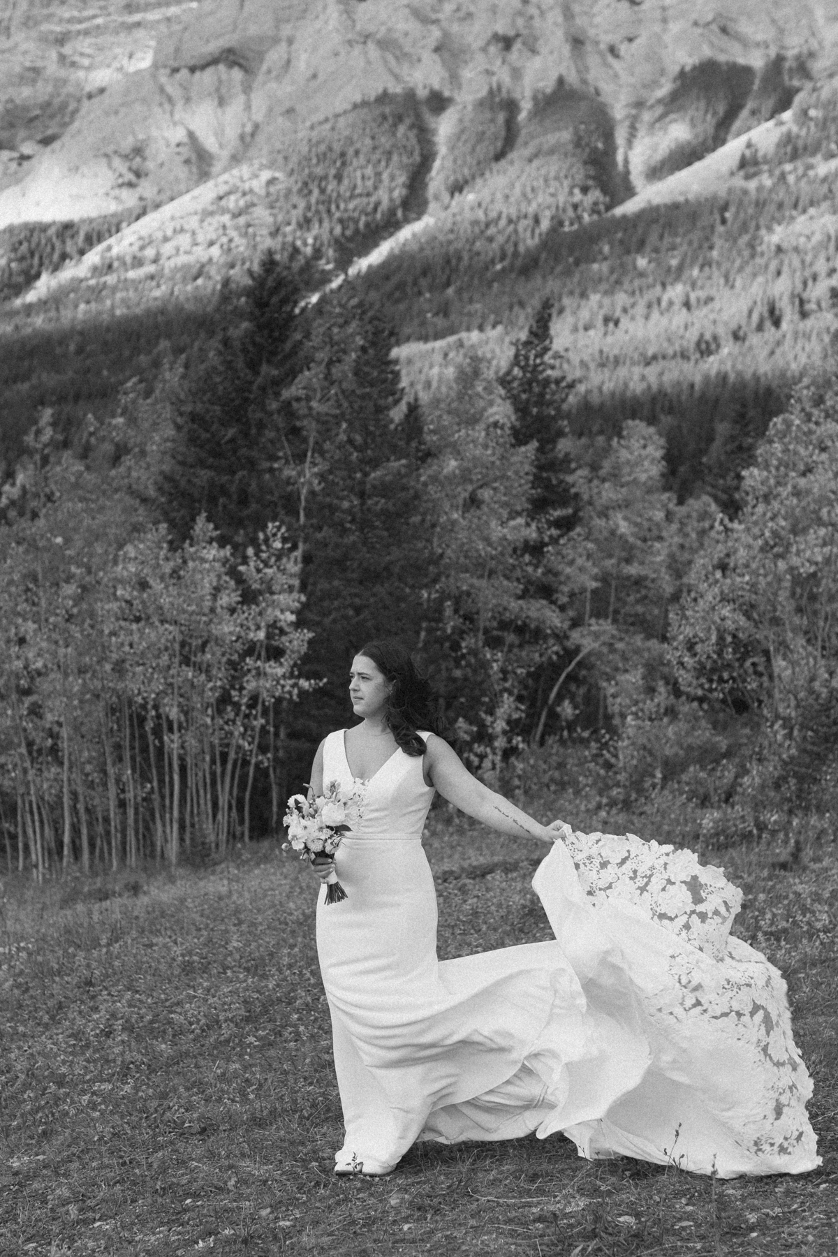 A couple looking at the camera and smiling during their Kananaskis Country ceremony