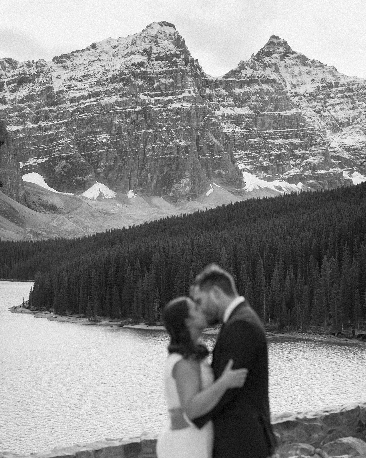 a couple kissing at moraine lake during their banff elopement