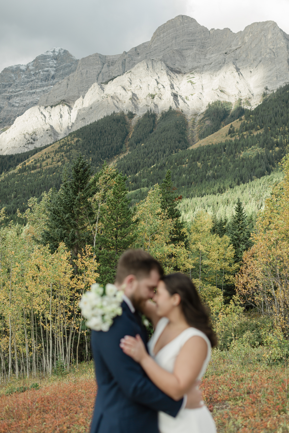 A couple smiling during their Kananaskis Country ceremony