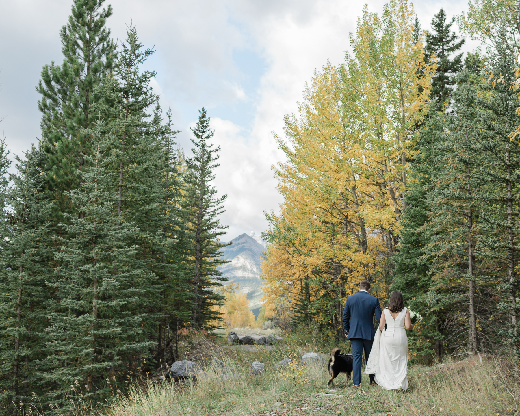 A couple walking during their elopement near Mount Kidd