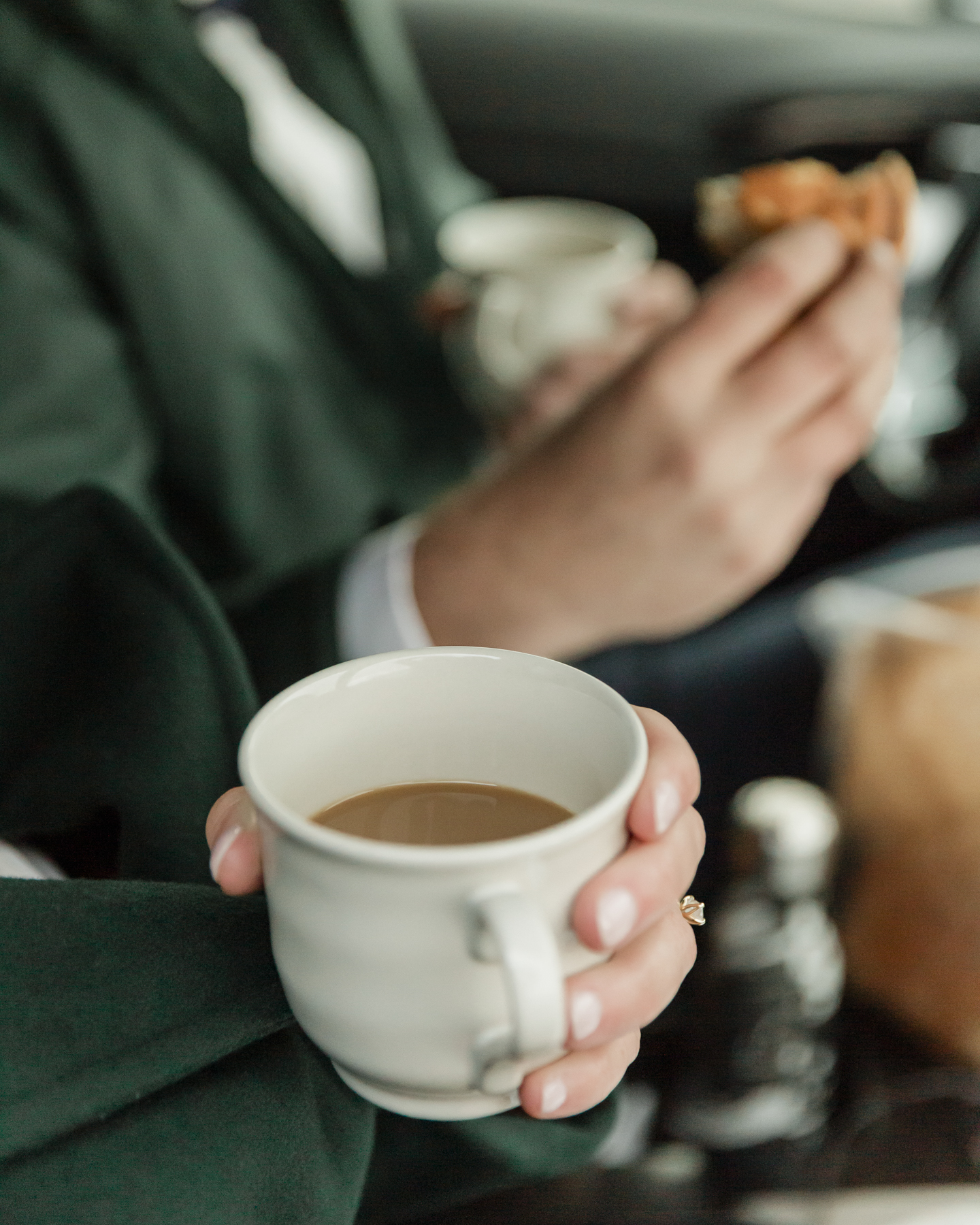 A couple warming up in the car with hot coffee and snacks during their Iceland wedding on the Snæfellsnes Peninsula 