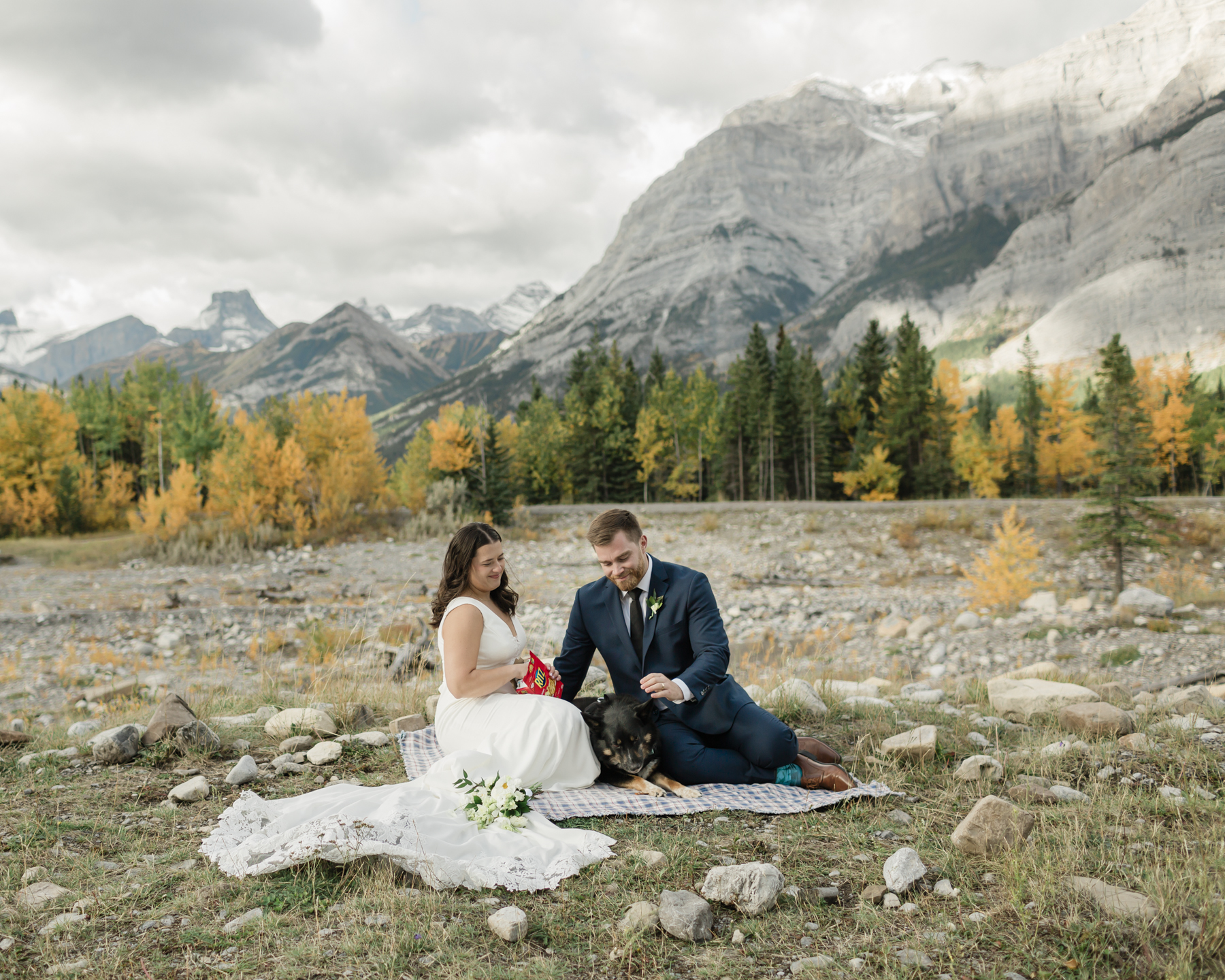 A couple celebrating with a picnic during their elopement near Mount Kidd