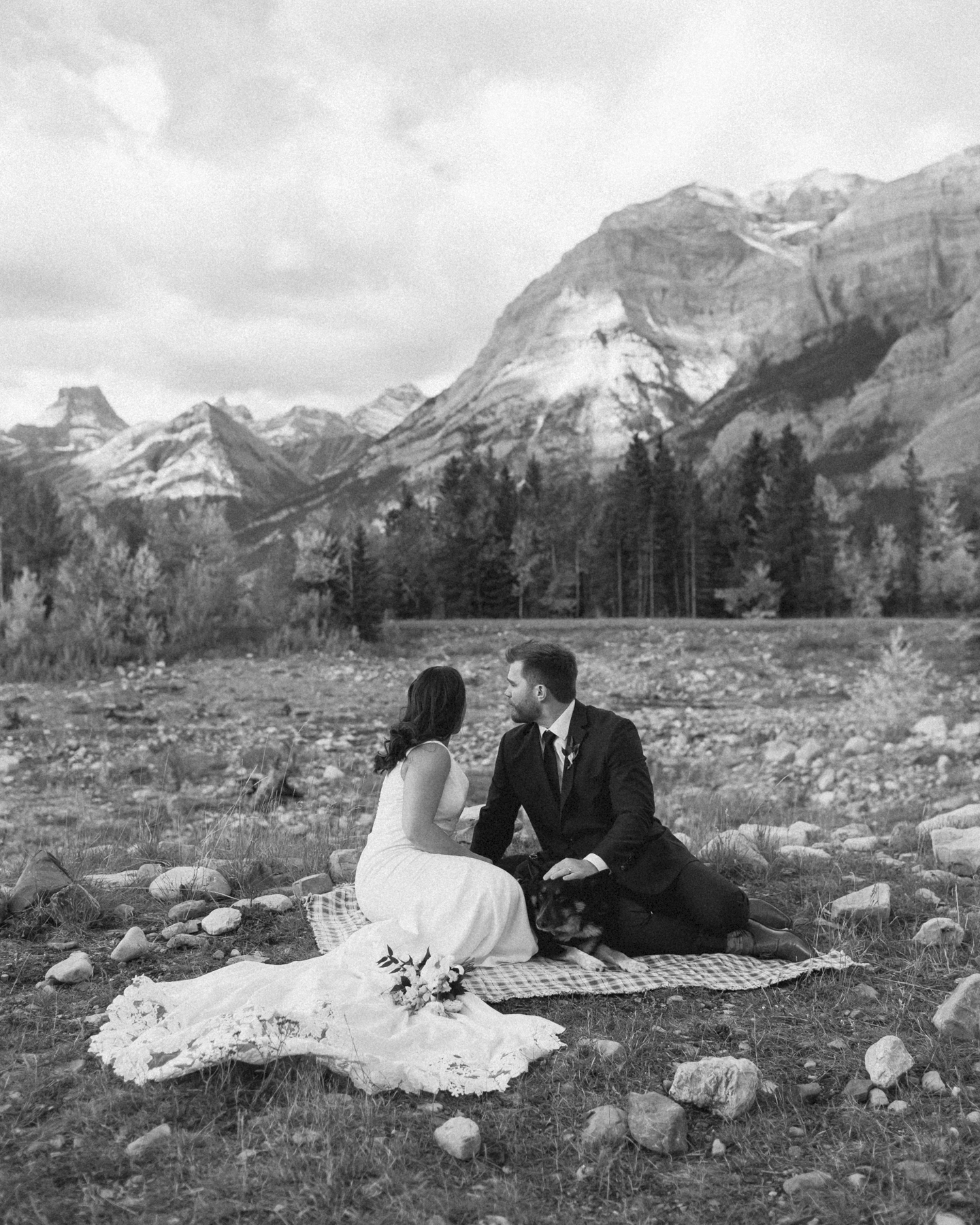 A couple celebrating with a picnic during their elopement near Mount Kidd