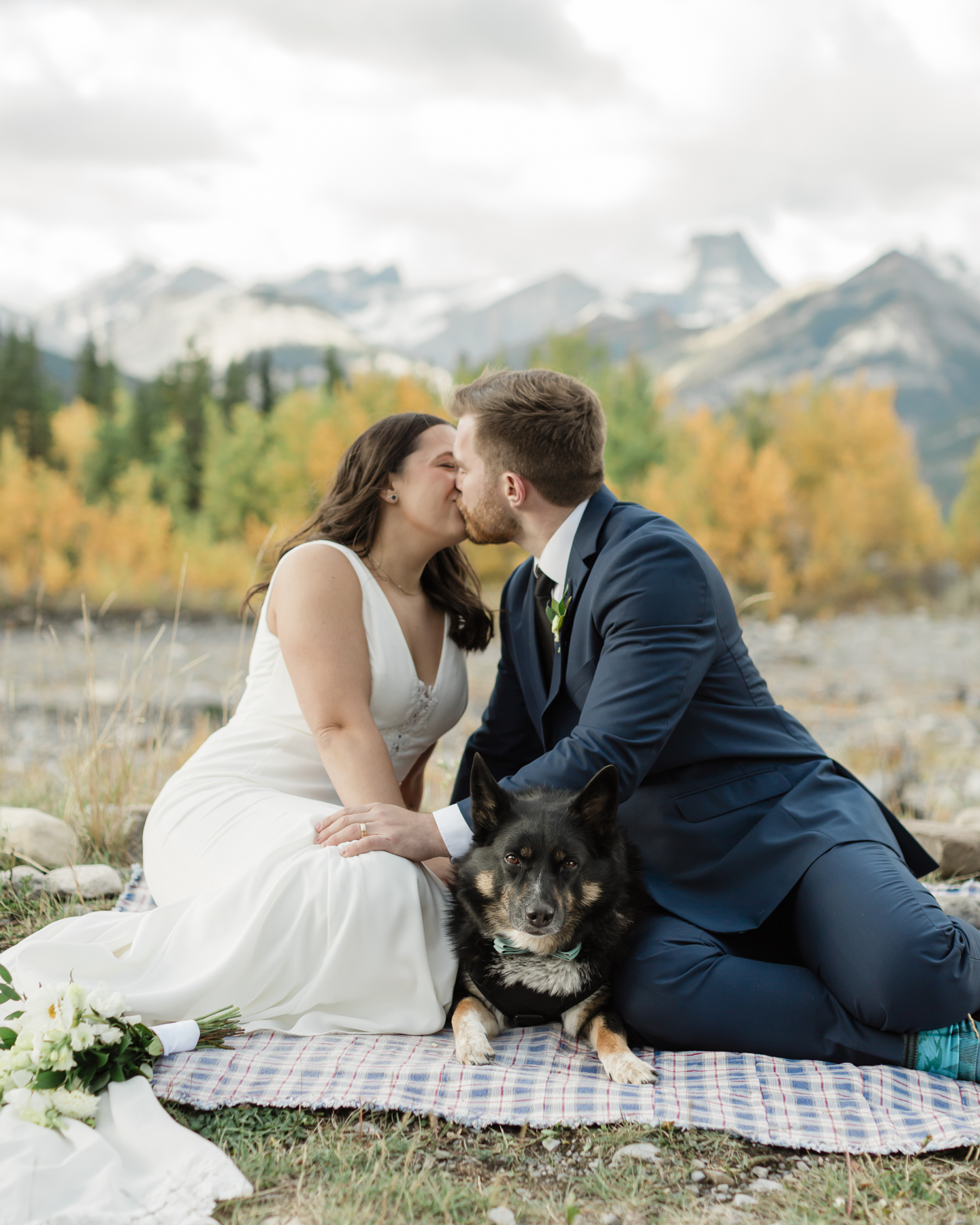 A couple celebrating with a picnic during their elopement near Mount Kidd