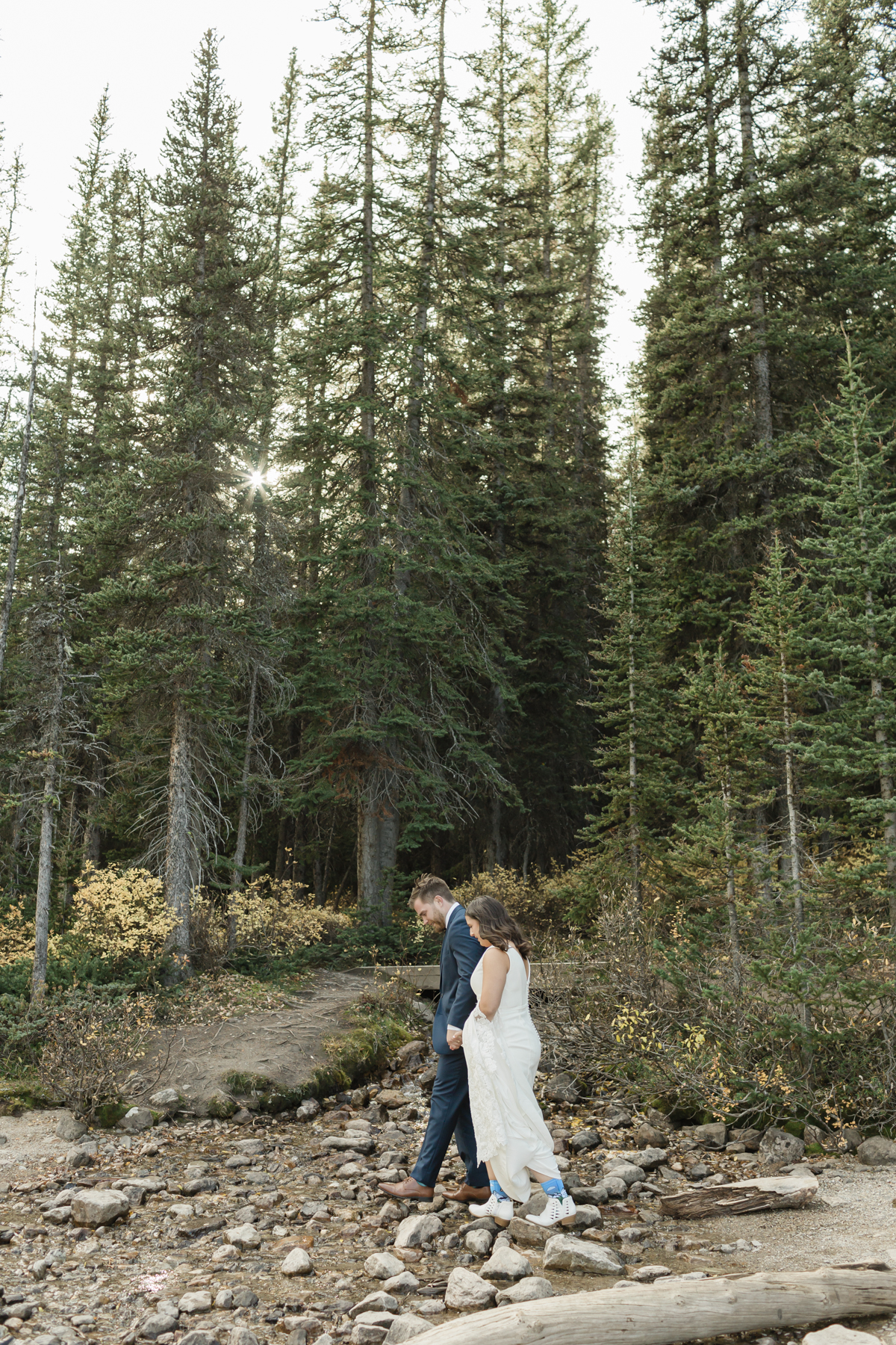 A couple walking around Moraine Lake during their elopement 