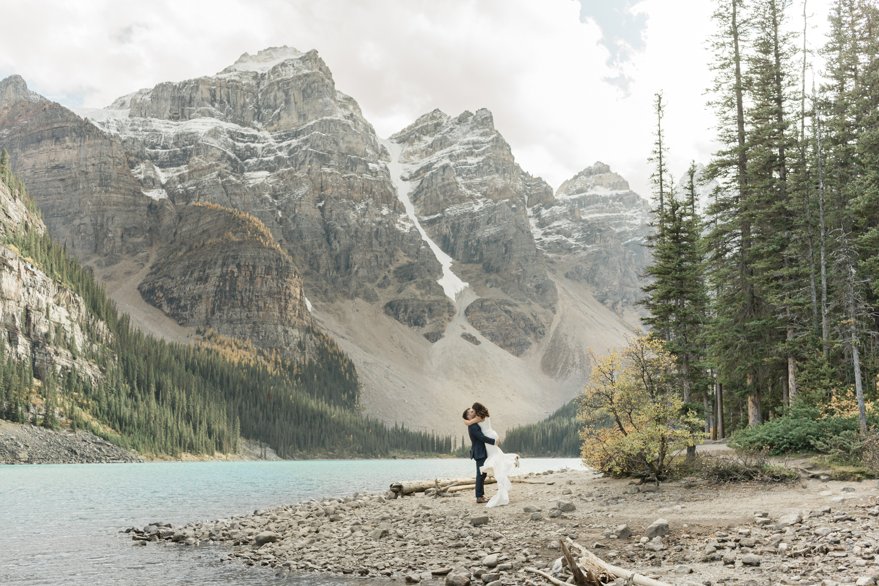 A couple walking around Moraine Lake during their elopement 