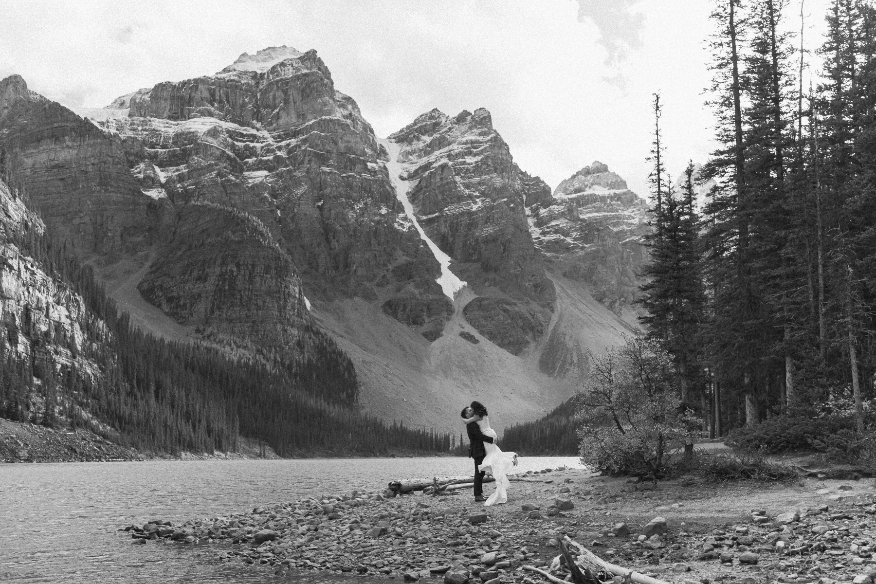 A couple walking around Moraine Lake during their elopement 