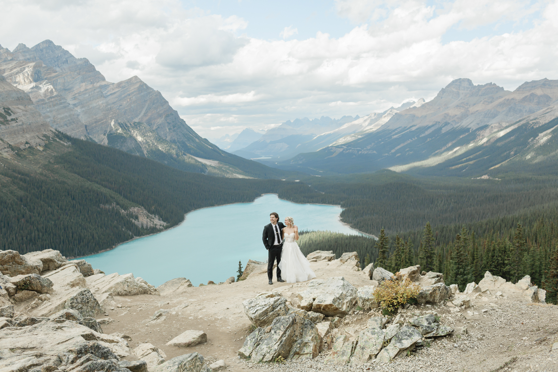 A couple looking at the mountains after they got married in Banff National Park at Peyto Lake