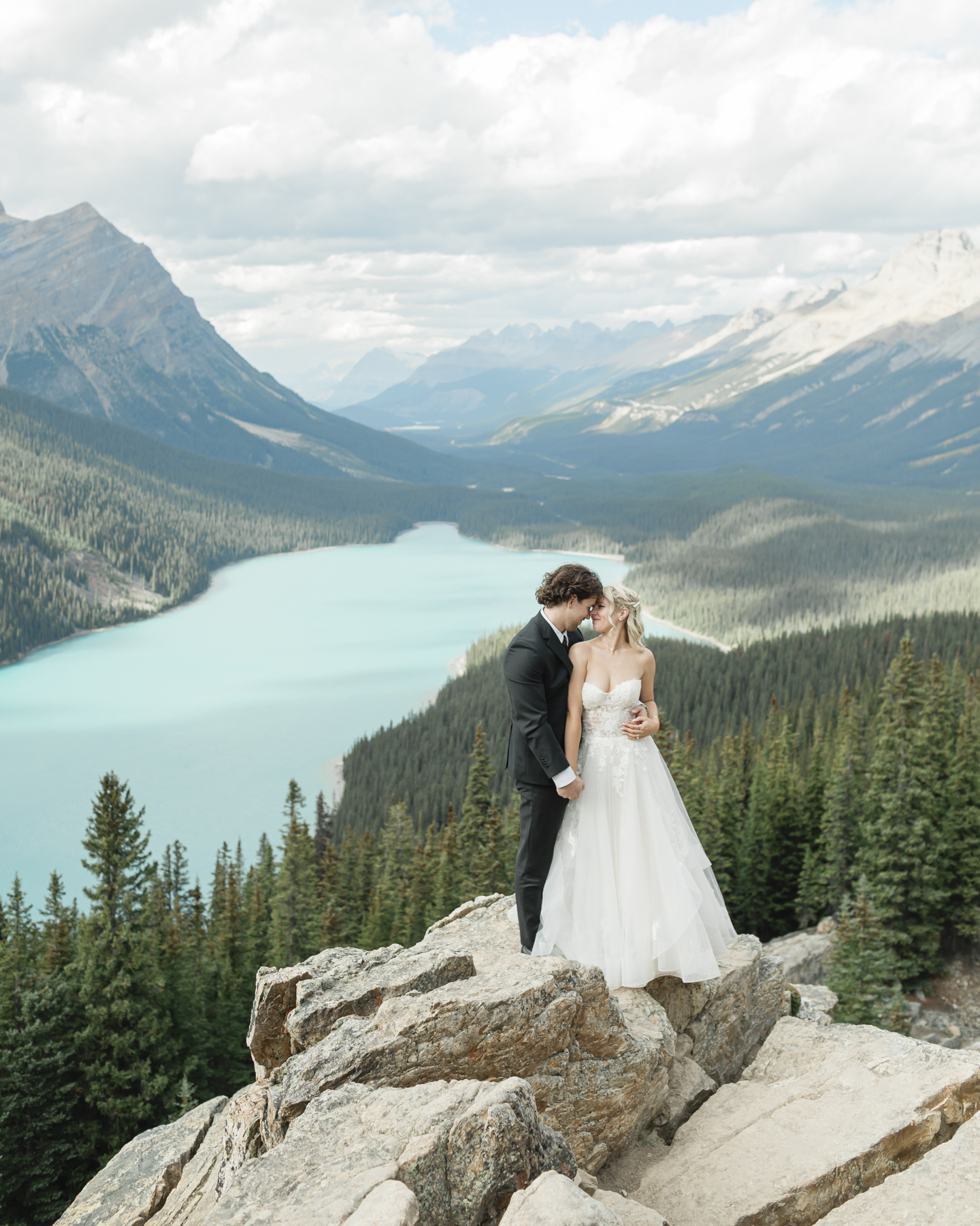 A couple looking at the mountains after they got married in Banff National Park at Peyto Lake