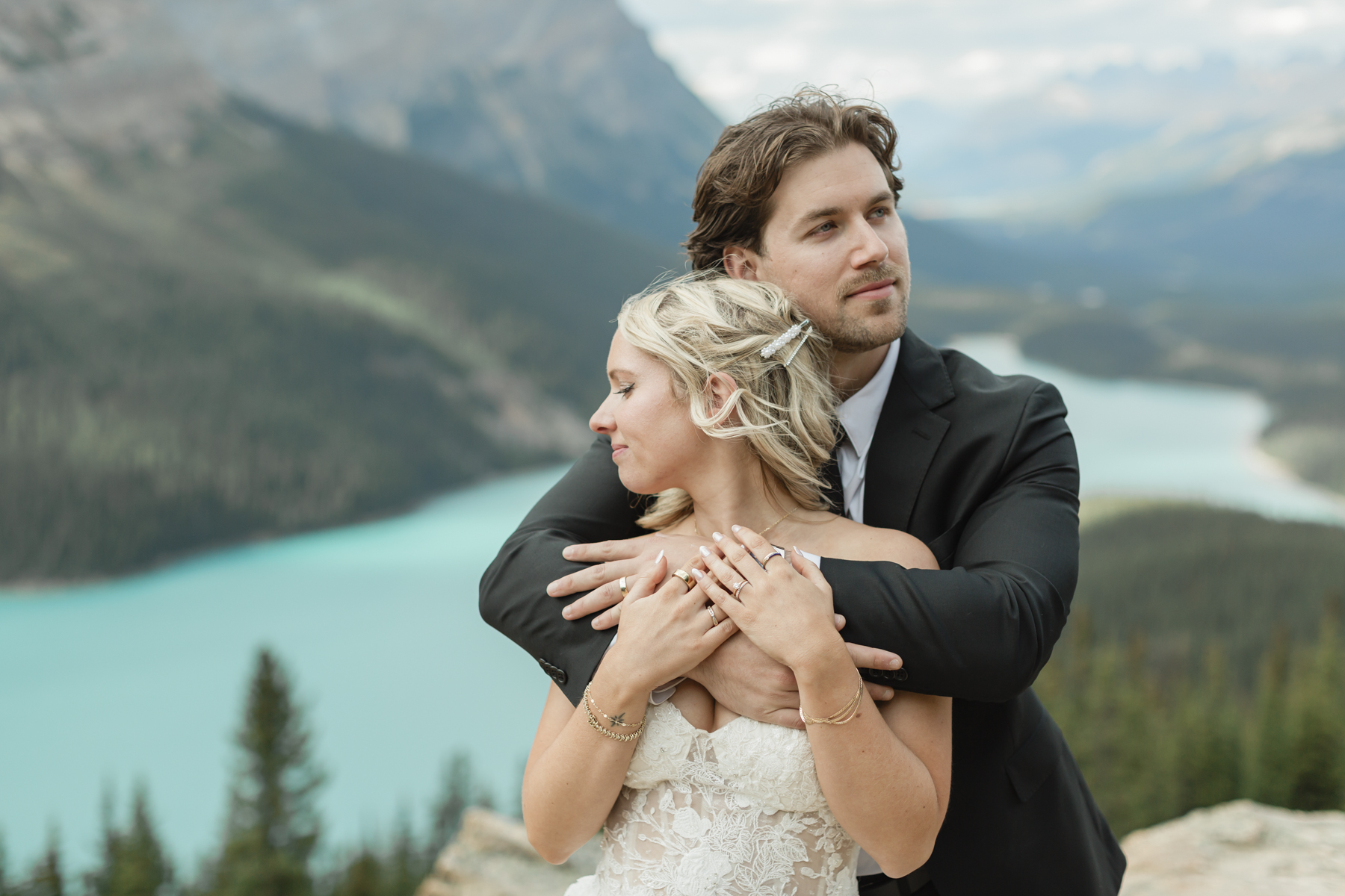 A couple embracing and looking in opposite directions after their wedding 