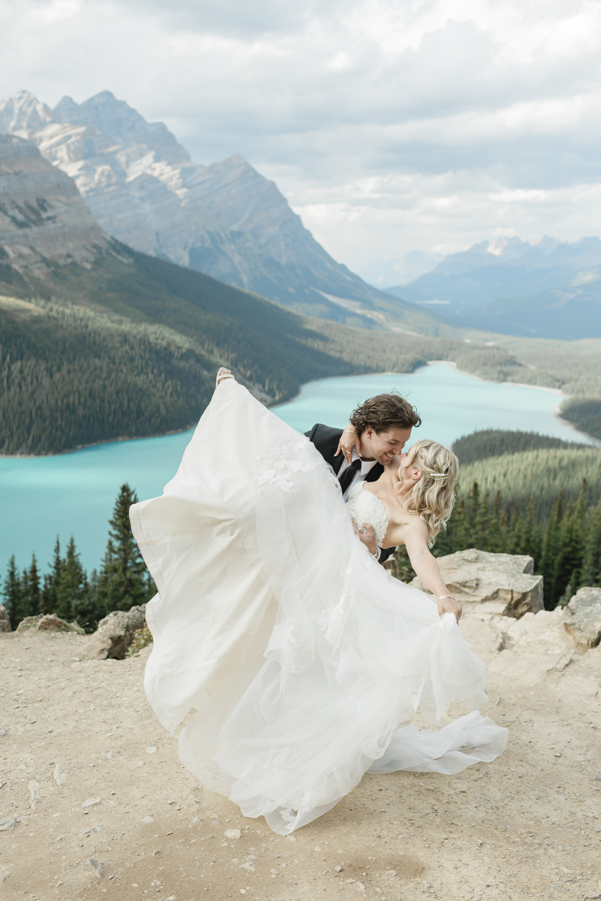 A couple dancing at the Peyto panoramic lookout after their elopement in Banff 