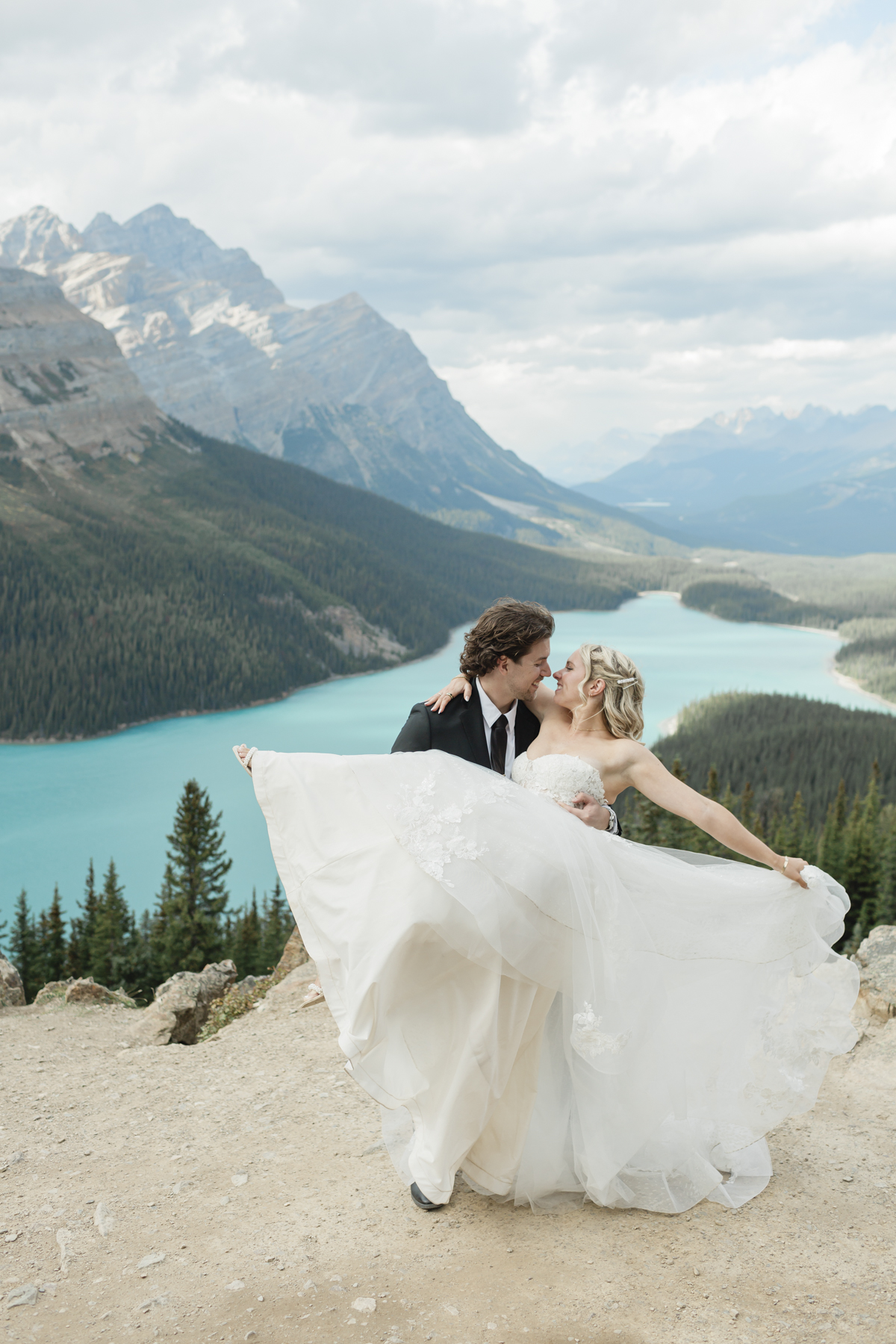 A couple dancing at the Peyto panoramic lookout after their elopement in Banff 