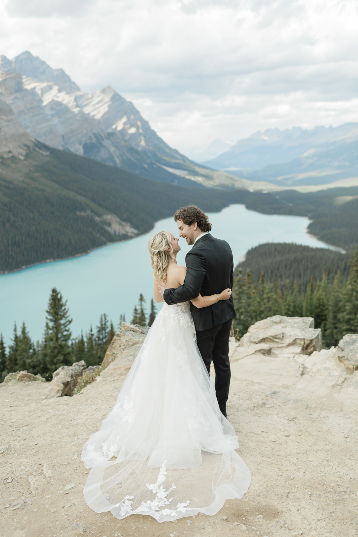 A couple embracing and looking in opposite directions after their wedding 