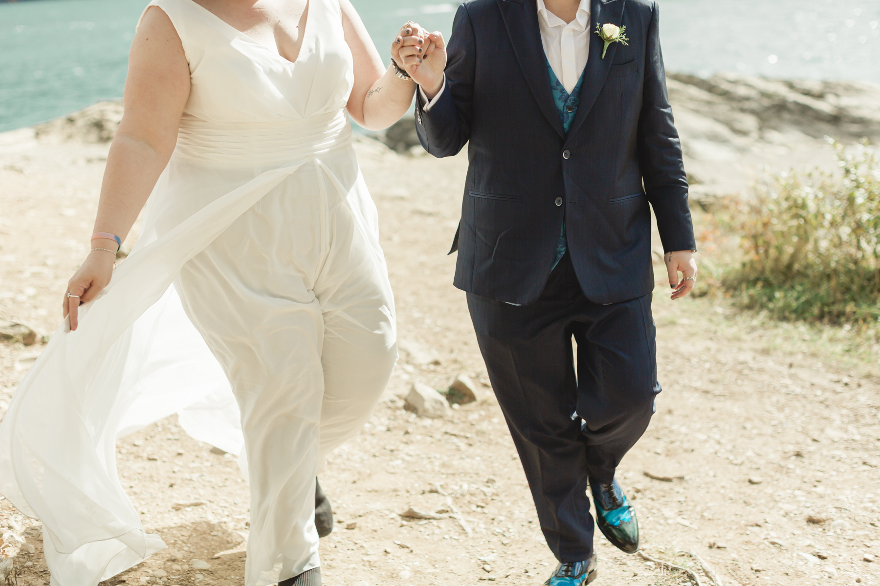 A LGBTQIA+ couple after their wedding exploring Lake Minnewanka 